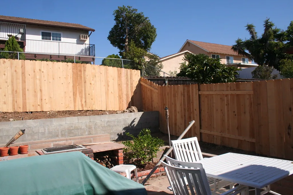 New wood board fence around a backyard
