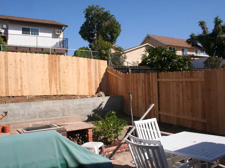 New wood board fence around a backyard