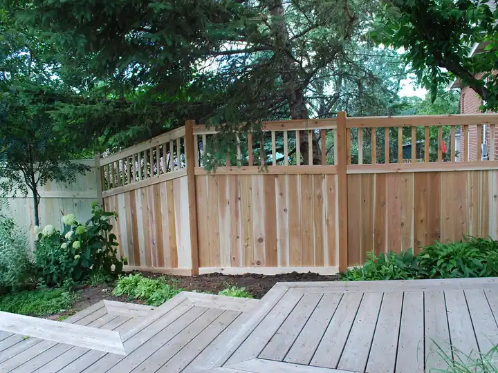 Tall wood privacy fence along a side yard